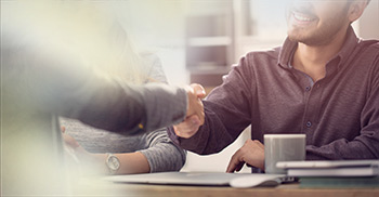 relieved man shakes hands with advisor 