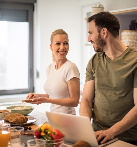 Happy couple cooks in kitchen