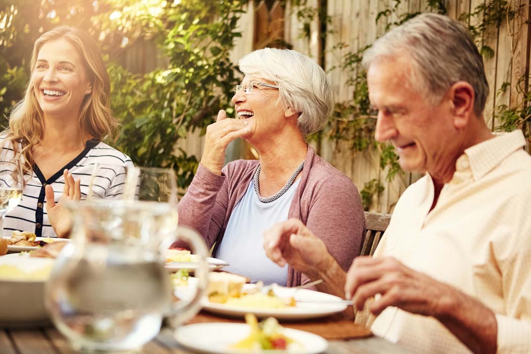 Older family having barbecue in the back yard