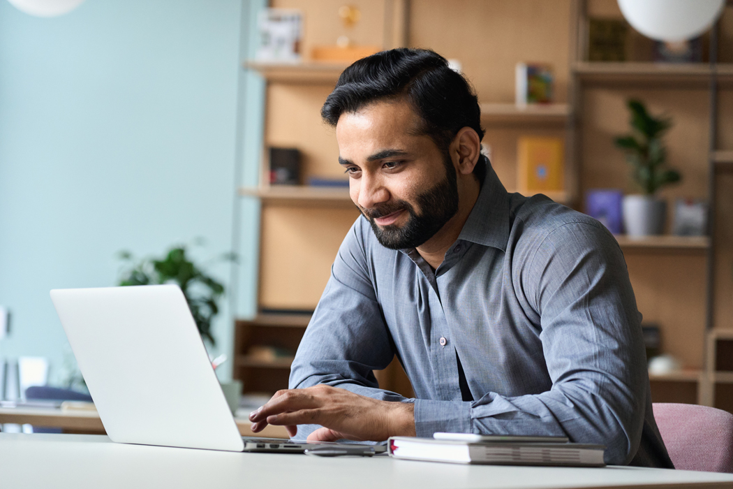 man uses laptop to review his RRSP balance.