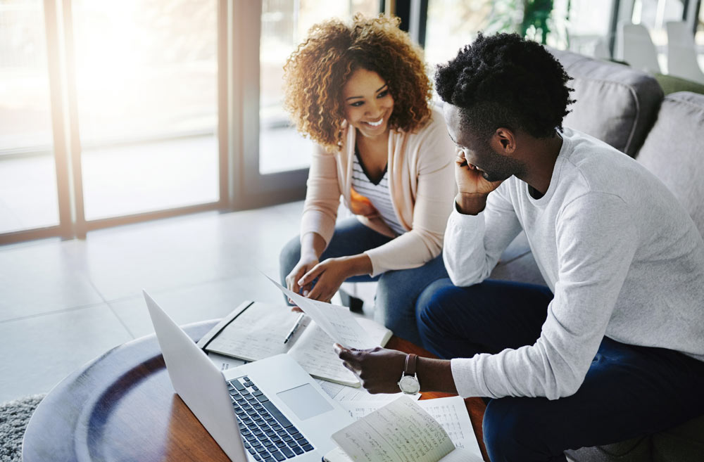 couple happily reviewing their financial plans